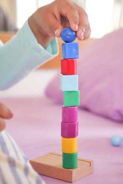 istock child hand playing with pyramid toy 1620689384