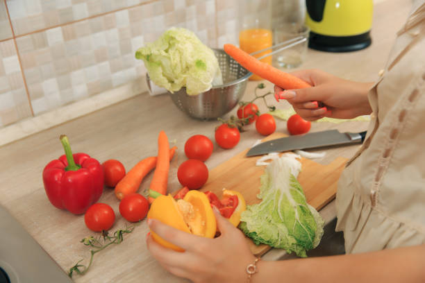 istock Girl cutting vegetables for salad 1620690424