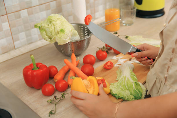 istock Girl cutting vegetables for salad 1620690435