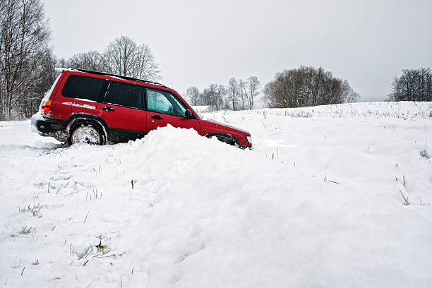 Red truck stuck in a ditch in the wintertime Car in a ditch ditch stock pictures, royalty-free photos & images