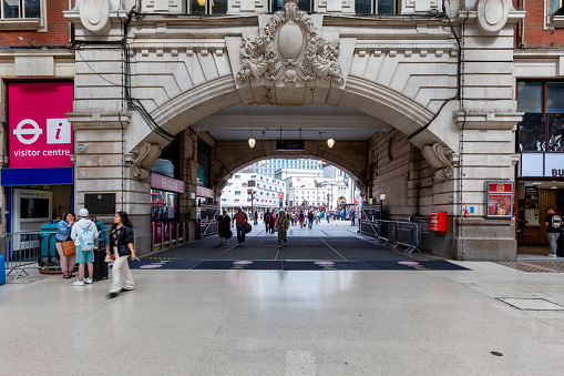 London, UK: Aug 14, 2023: Victoria station in central London with commuters waiting for their trains or walking around the station. Victoria station is one of the main train stations in London with many routes serving the south of England.