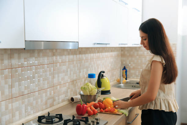 istock Girl cutting vegetables in the kitchen 1620742760