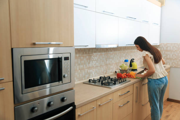 istock Girl with long hair cuts vegetables in the kitchen 1620744076
