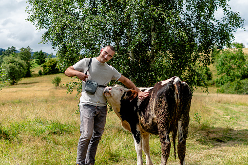 This image resonates with the harmony and affection between a man and his cow, capturing the genuine connection they share
