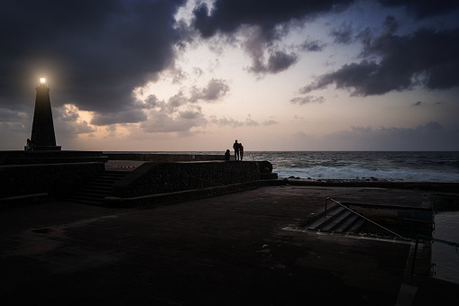 Romantic couple by the lighthouse  of Bajamar in Tenerife Canarias