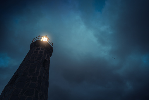 Lighthouse of Bajamar in Tenerife Canarias emitting light at twilight
