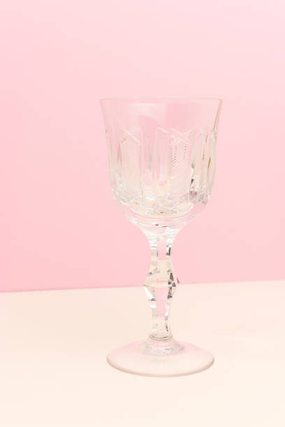 istock Crystal glass in front of pink background. 1620762011