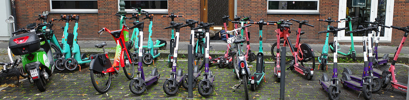 Düsseldorf, Germany - Aug 2 2023 Rental e-scooters are parked chaotically. They are from Tier, Check and Voi.