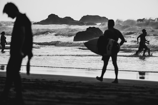 Taganana, Spain, June 29, 2023: Surfers enjoying big waves at sunset on June 29 2023 on the beach of Taganana, Tenerife, Canary Islands, Spain.