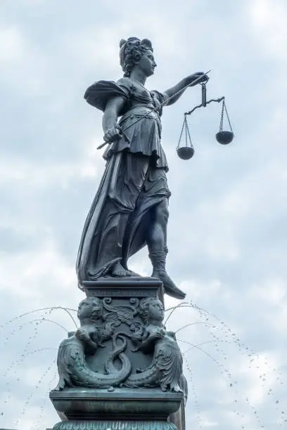 lady justice at the fountain at the Roemer square in Frankfurt, Germany