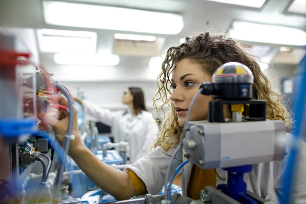 istock Beautiful young woman works in mechanical laboratory 1620780280