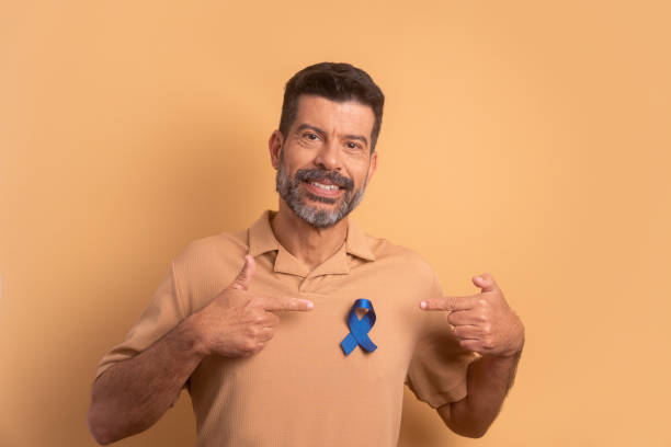 青いリボンを見せる男性。前立腺がん、意識のコンセプト。 - movember ストックフォトと画像
