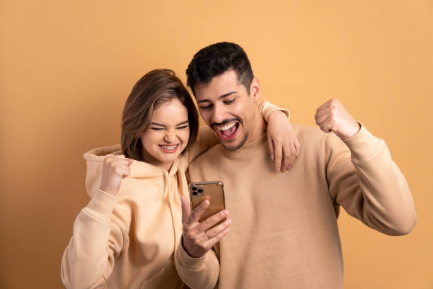 istock excited couple checking smartphone 1620784256