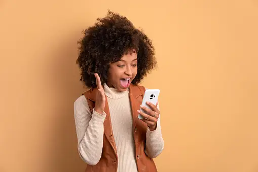 surprised woman looking at cell phone