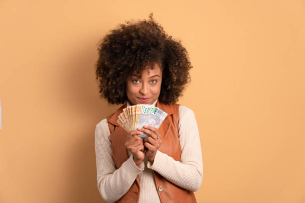 istock woman with brazil banknotes currency 1620784891