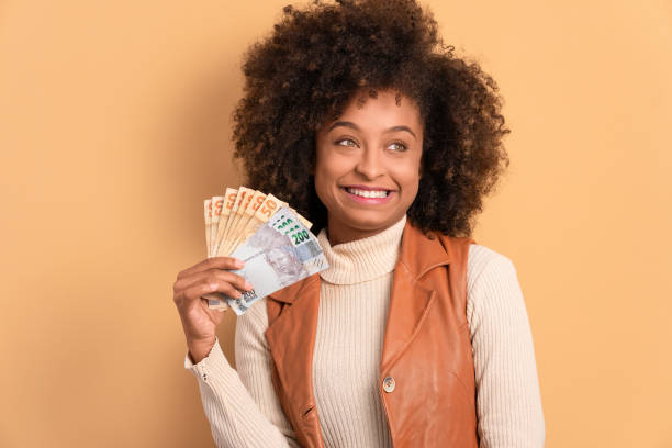 woman with brazil banknotes currency