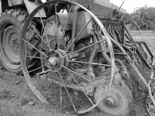 Plowed field by tractor in black soil on open countryside nature, tractor in plowed field, soil to growing tasty vegetables, organic plowed field under the clean dark sky is natural soil for tractor