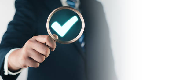 istock Digital Checklists, Rules of conduct rules and policies company, Regulations Terms and Conditions. Businessman holding magnifying glass and check mark icon, Show check the authenticity of the document 1620807722