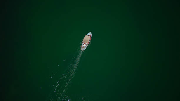 istock Fishing Boat On A Green Lake 1620840744