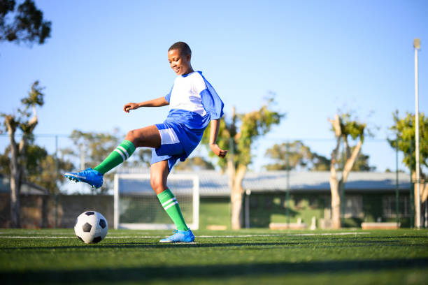 istock Low angle view woman kicks for goal 1620842638