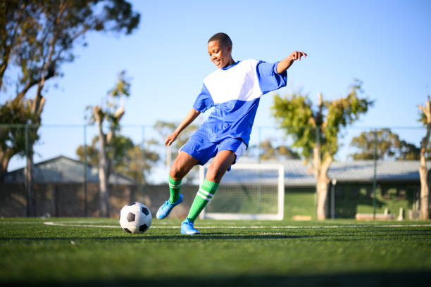 istock Low angle view woman kicks for goal 1620842648