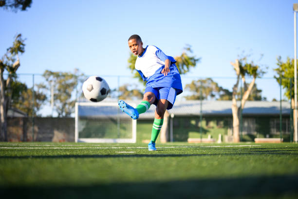 istock Low angle view woman kicks for goal 1620842656