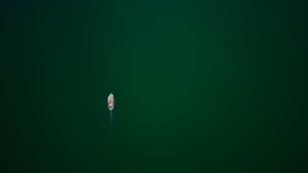 istock Fishing Boat On A Green Lake 1620844759