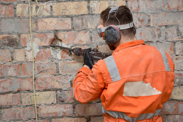 istock Worker removing old groove for electrical wire with 
hammer drill. 1620862353