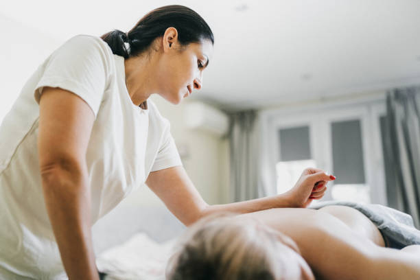 Woman enjoying reiki healing treatment, reiki healer holding her hand