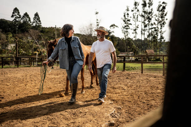 istock Father and daughter talking and walking with horse on a ranch 1620873410