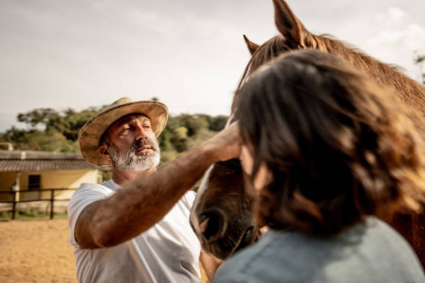 istock Father petting his horse on a ranch 1620873962