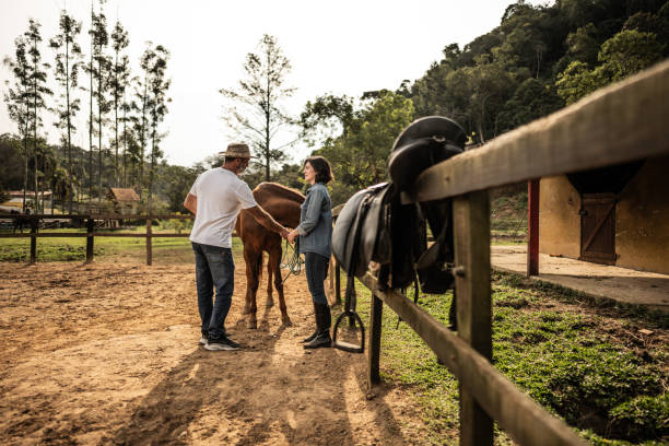 istock Father and daughter talking on a ranch 1620875038