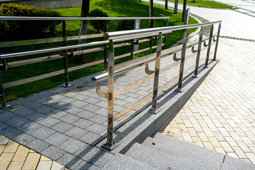 walkway made of granite and marble with chrome railings, in the landscape design of architecture