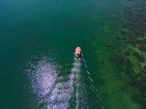 Aerial view of a small excursion boat on the lake.