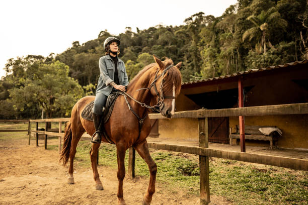 istock Young woman horseback riding on a stable 1620882703