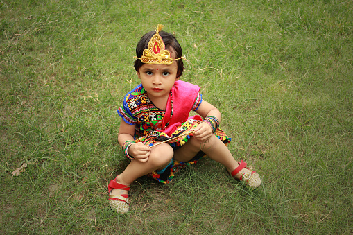 Portrait of small baby girl and she is in traditional Radha costume on Krishna Janmashtami. Krishna Janmashtami, also known simply as Krishnashtami, Janmashtami, or Gokulashtami, is an annual Hindu festival that celebrates the birth of Krishna, the eighth avatar of Vishnu. In certain Hindu texts, such as the Gitagovinda, Krishna has been identified as supreme God and the source of all avatars.