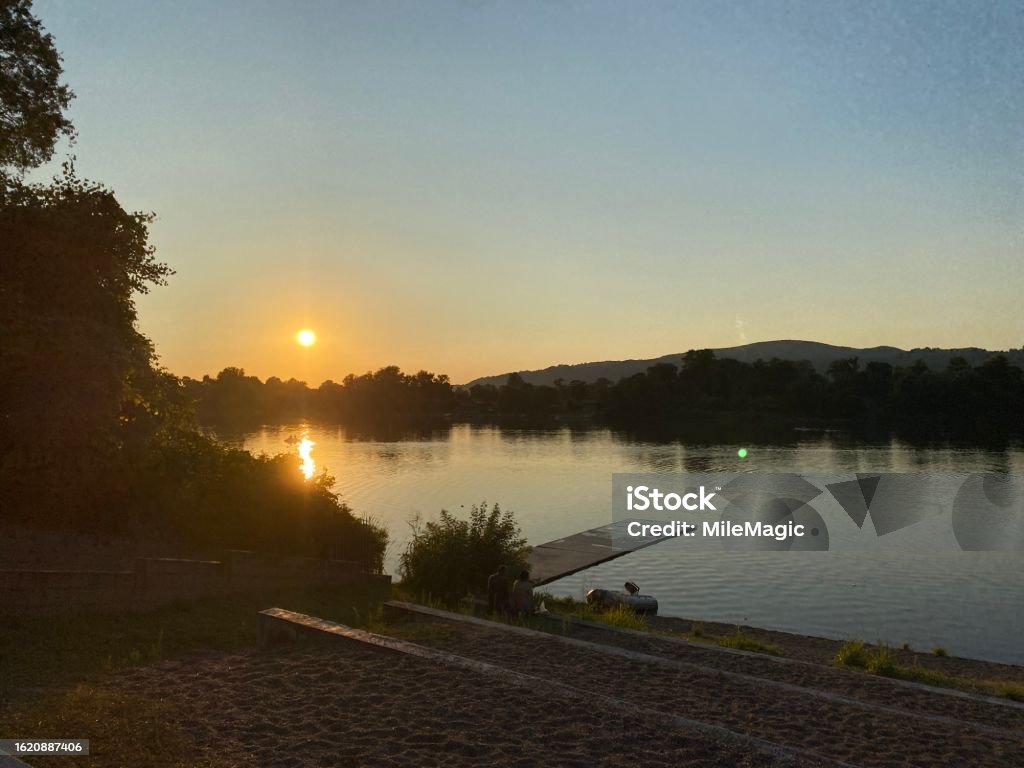Beautiful Riverside Sunset Riverside Sunset Stock Photo - Download Image Now - Tranquility, Boat ...
