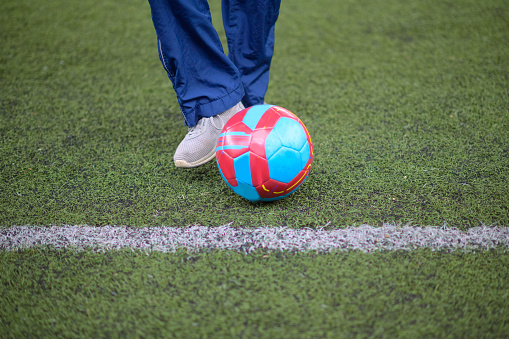 Soccer ball warm up dribble on artificial turf with line