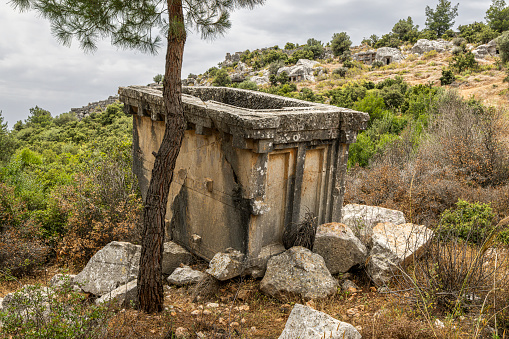 War Memorial for Balkan & Greek Turkish Wars (1912-1921) at Church of Agios Nikolaos (Saint Nicholas) in Pyrgos Kallistis on Santorini, Greece, with names visible and people in the background