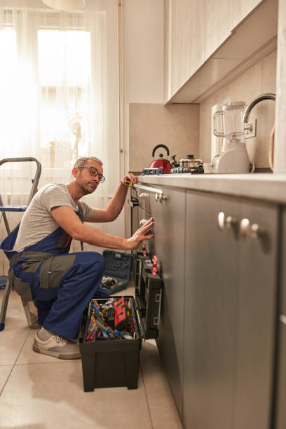 istock Handyman fixing kitchen cabinets in the apartment. 1620896559