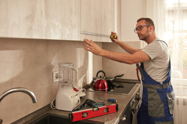 istock Handyman fixing kitchen cabinets in the apartment. 1620897332