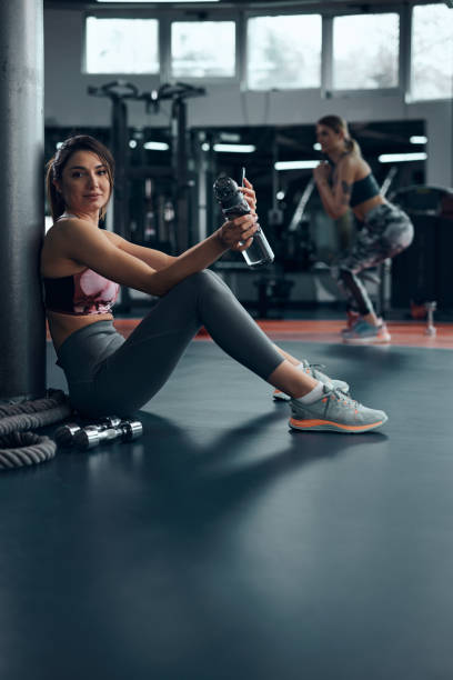 istock Sporty lady making pause in a gym after exercise. 1620908687