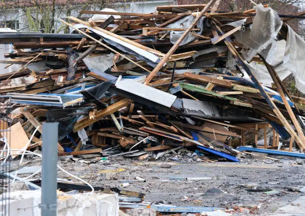 Demolition work concept: a large pile of rubble, debris, wood after demolition of a building, selective focus