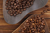 Coffee beans in wooden plates.