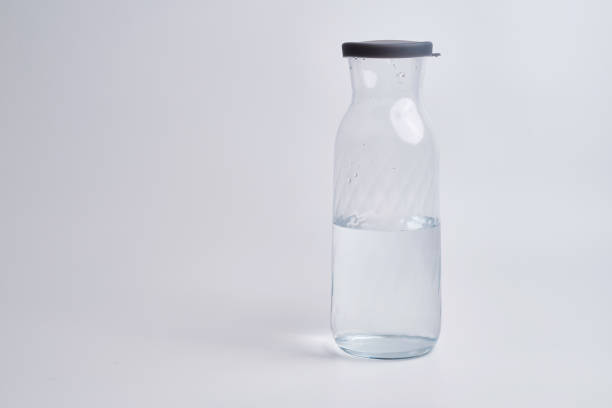 istock Glass bottles with water on a light background. Place for text 1620940126