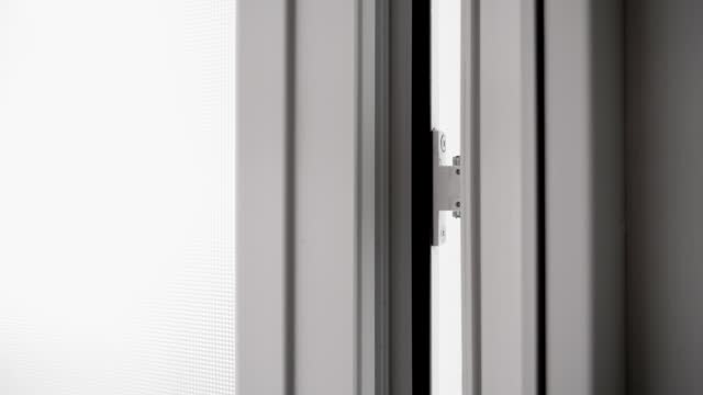 Typical plastic doors close and open, close-up of the rail