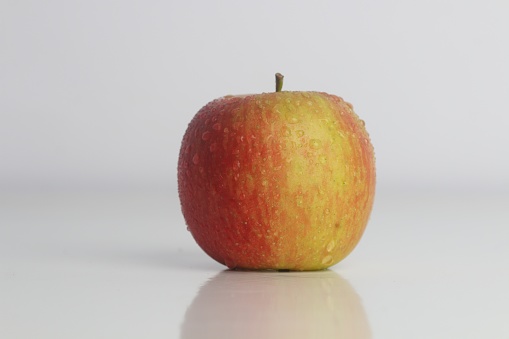 A red and green apple on a white background