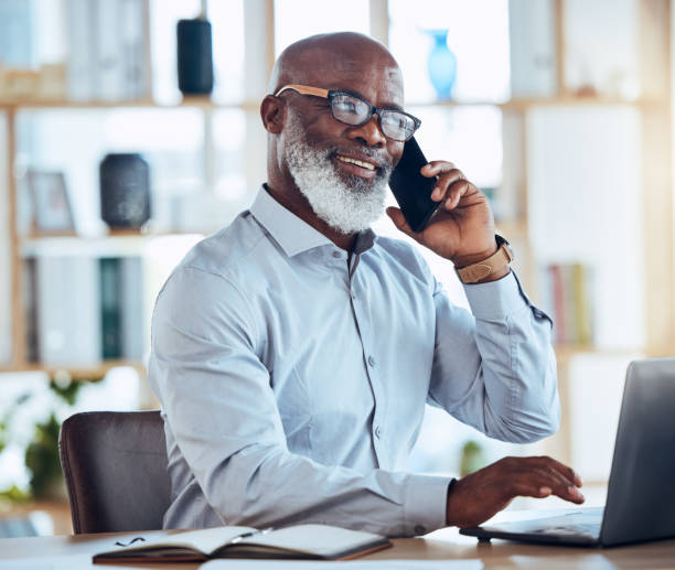 istock Black man, laptop or phone call for corporate networking, negotiation or client rapport for finance loan deal. Smile, happy or talking businessman on mobile communication technology for conversation 1620956559