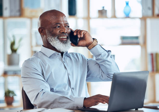 istock Talking black man, laptop or phone call in corporate networking, negotiation or client rapport on finance loan deal. Smile, happy or ceo businessman on mobile communication technology or conversation 1620956589