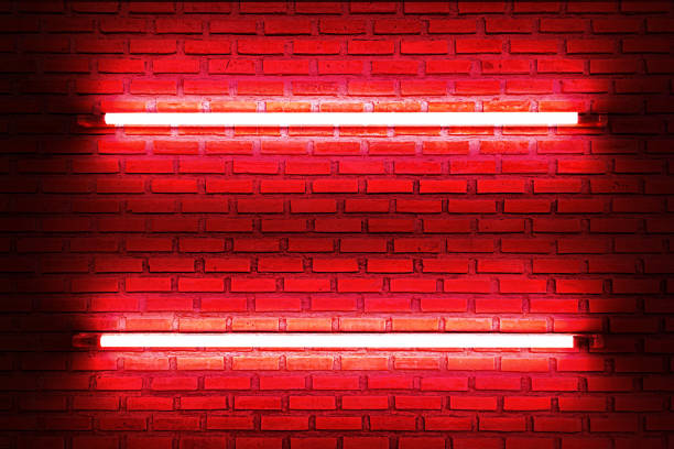 istock Two red neon bulbs on empty brick wall with glowing red neon lights. texture background. 1620964967
